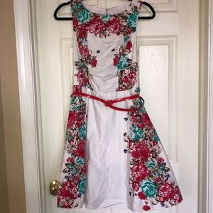 White floral dress with red belt